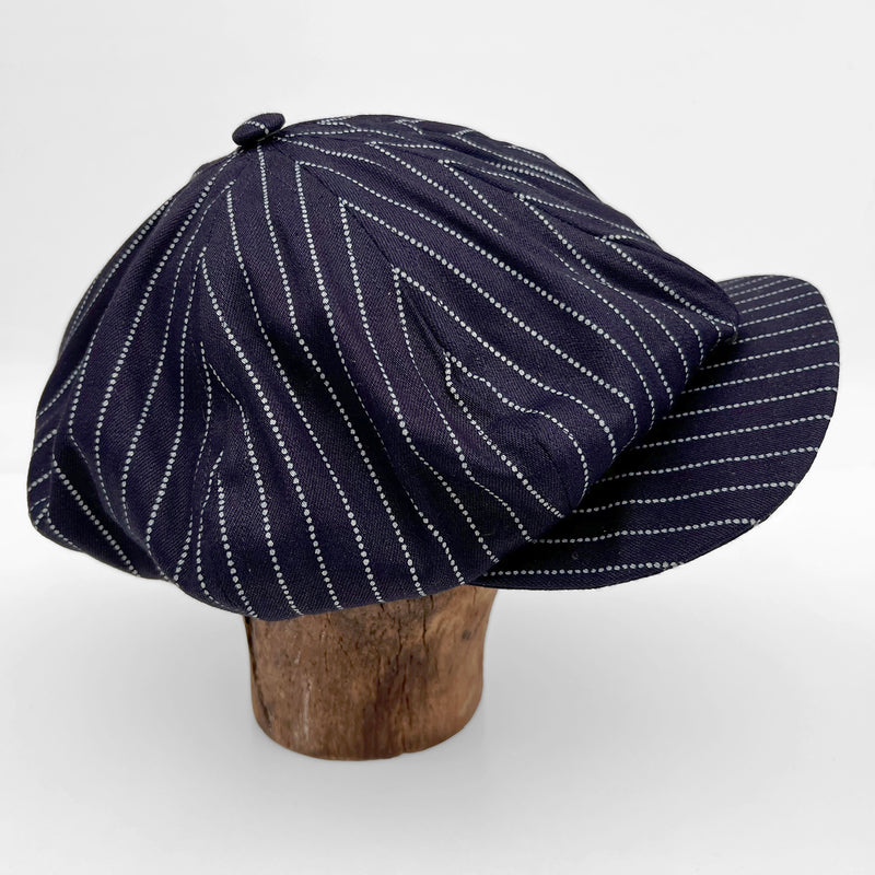 The Scuttler Cap is an eight panel ‘newsboy’ style hat, with an original Mister Freedom® pattern. It can be worn and shaped in several fashions, straight, tilted to the side or back, un-snapped, backwards 
